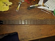 Chocolate-colored Wood Filler on the Rosewood Fretboard