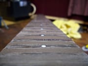 Chocolate-colored Wood Filler on the Rosewood Fretboard